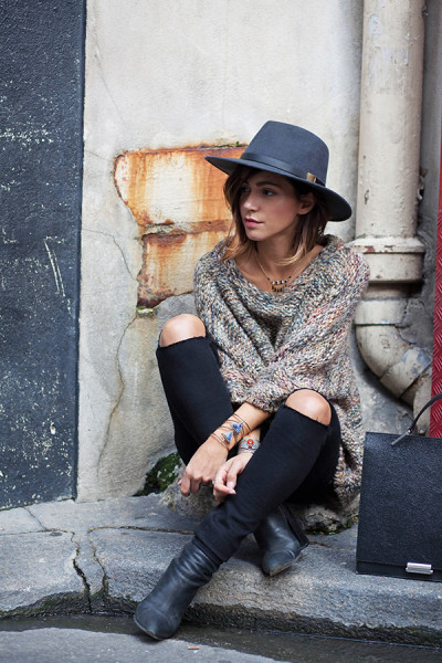Zoé Alalouch accessorises a beige knit with alternative jewellery and a wide brimmed hat.