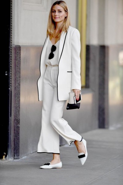 classic ivory suit trimmed in black with Jimmy Choo pointy-toe flats and a Céline zip pouch